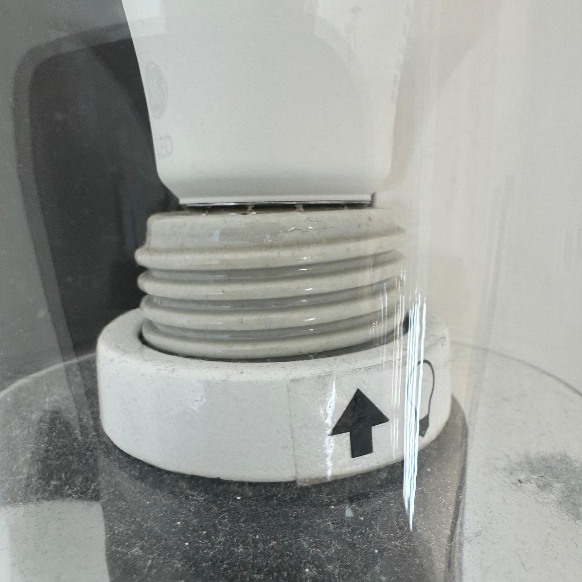 Light fixture before cleaning — dust and debris inside the glass shade