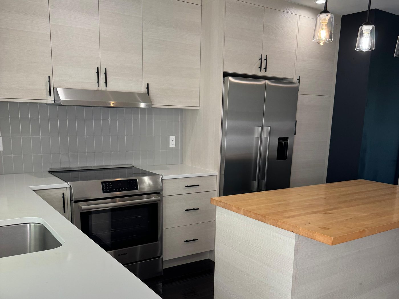 Modern kitchen with spotless counters and stainless appliances after cleaning